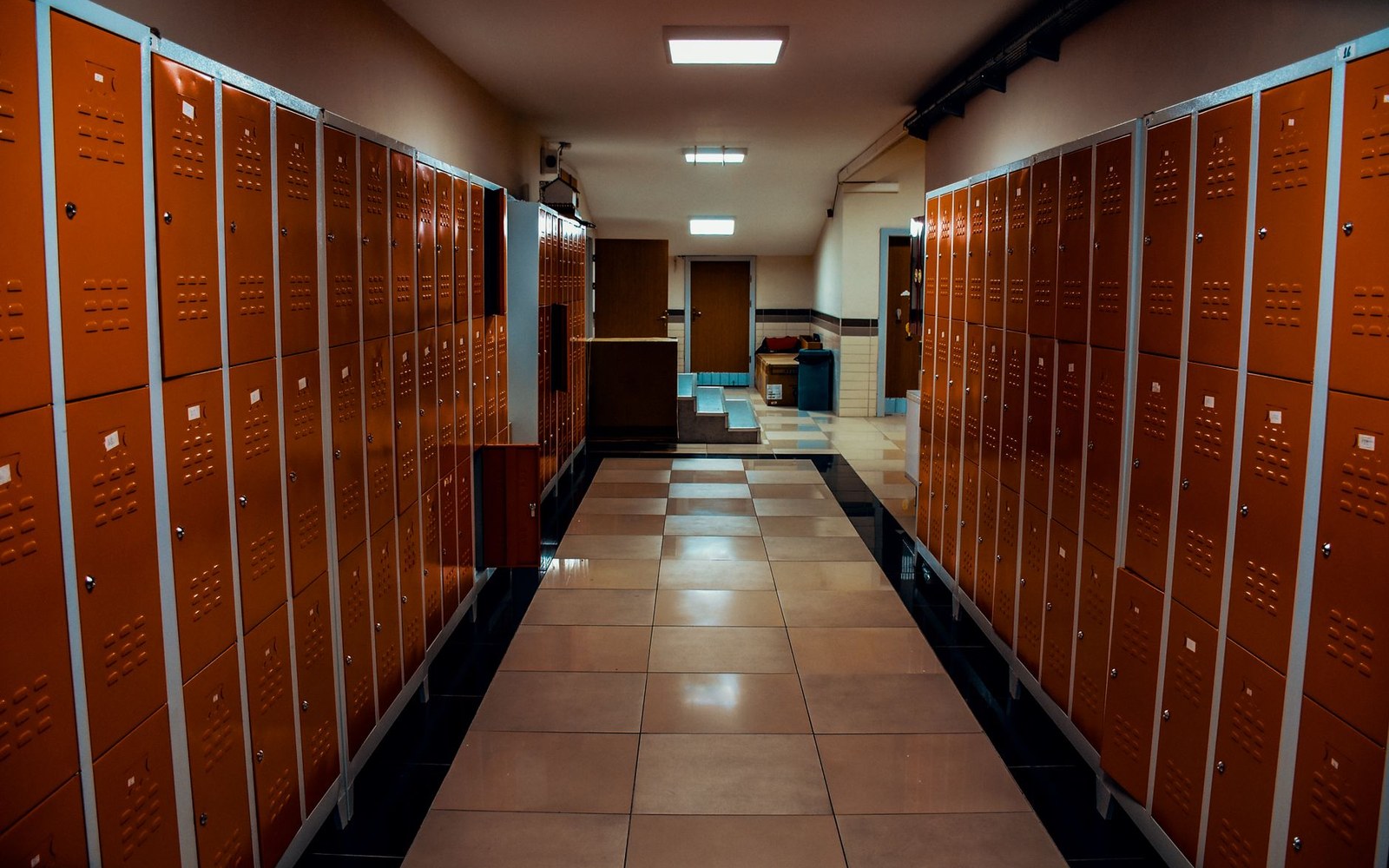 Empty locker room with bare benches after a game